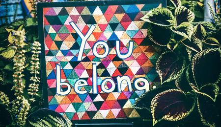 Multicoloured sign with words 'you belong'